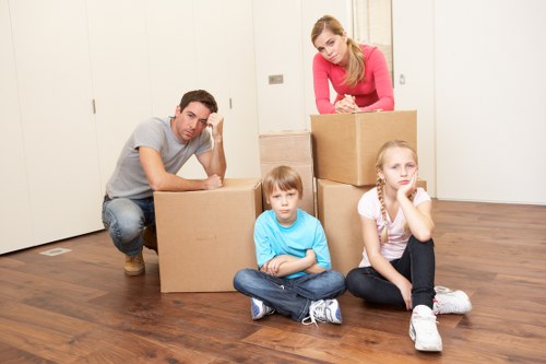 Team handling furniture and boxes during a house removal in South Wimbledon