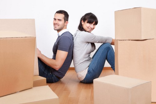 Loading household boxes and furniture into a van in South Wimbledon