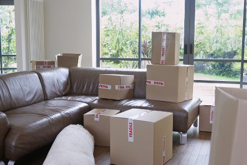Removalists carrying furniture through a South Wimbledon property